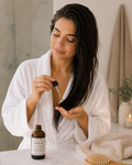 Woman applying SeliLeo Crystal Hair Oil to nourish hair lengths and add shine