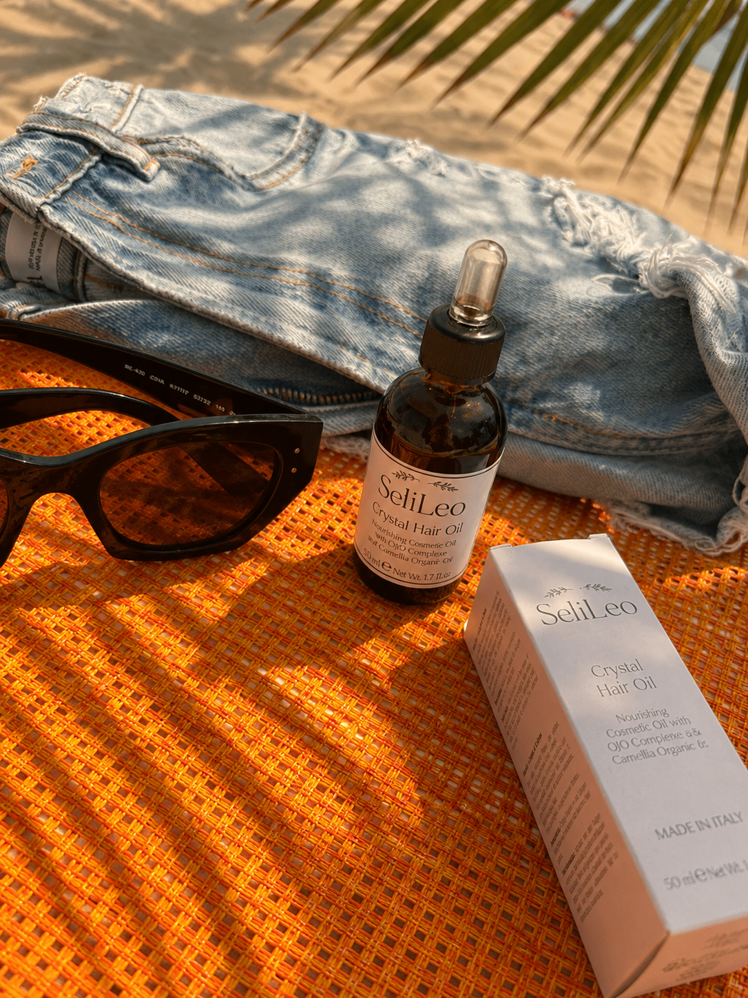 SeliLeo Crystal Hair Oil bottle in natural sunlight
